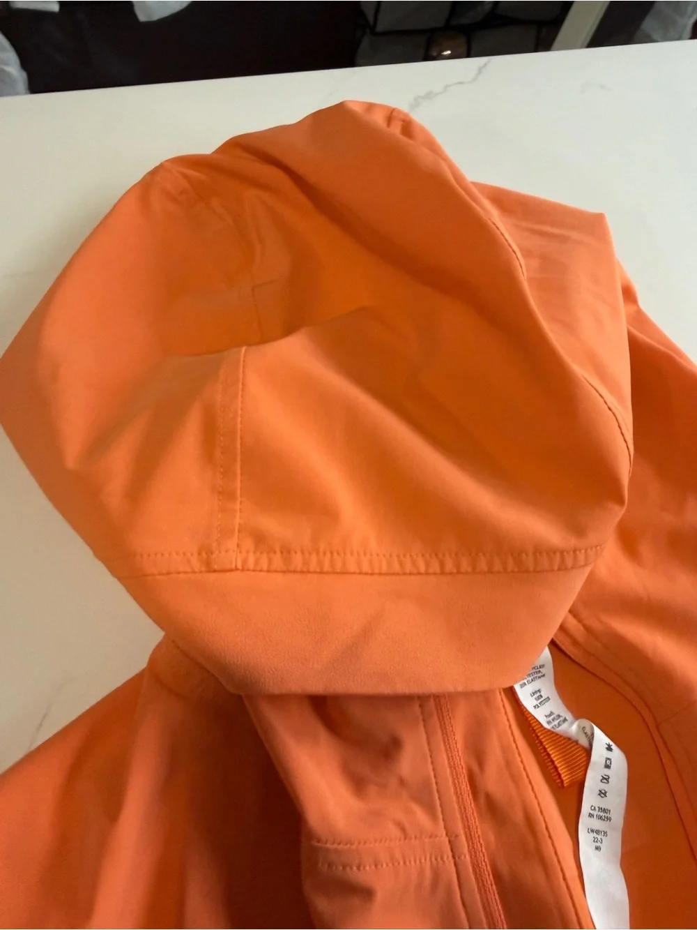 Lululemon hooded wind/rain jacket. Worn once, beautiful orange/peach color.
